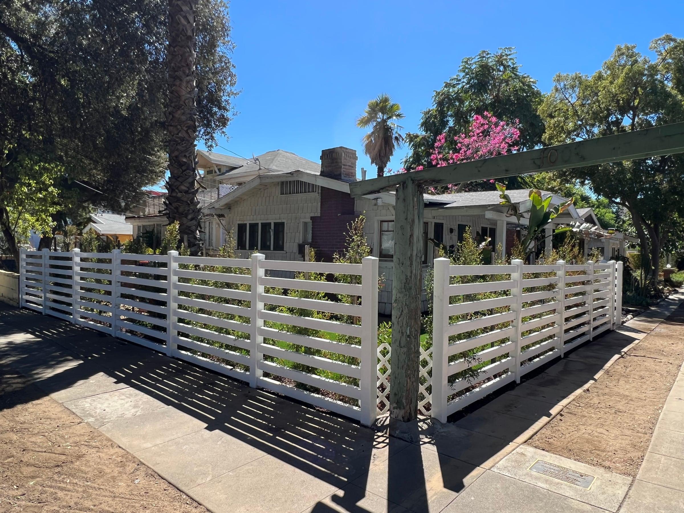 White PVC horizontal-slat fence and railing at a front porch