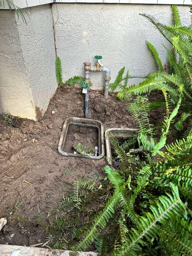 Irrigation shutoff valves exposed near planting beds