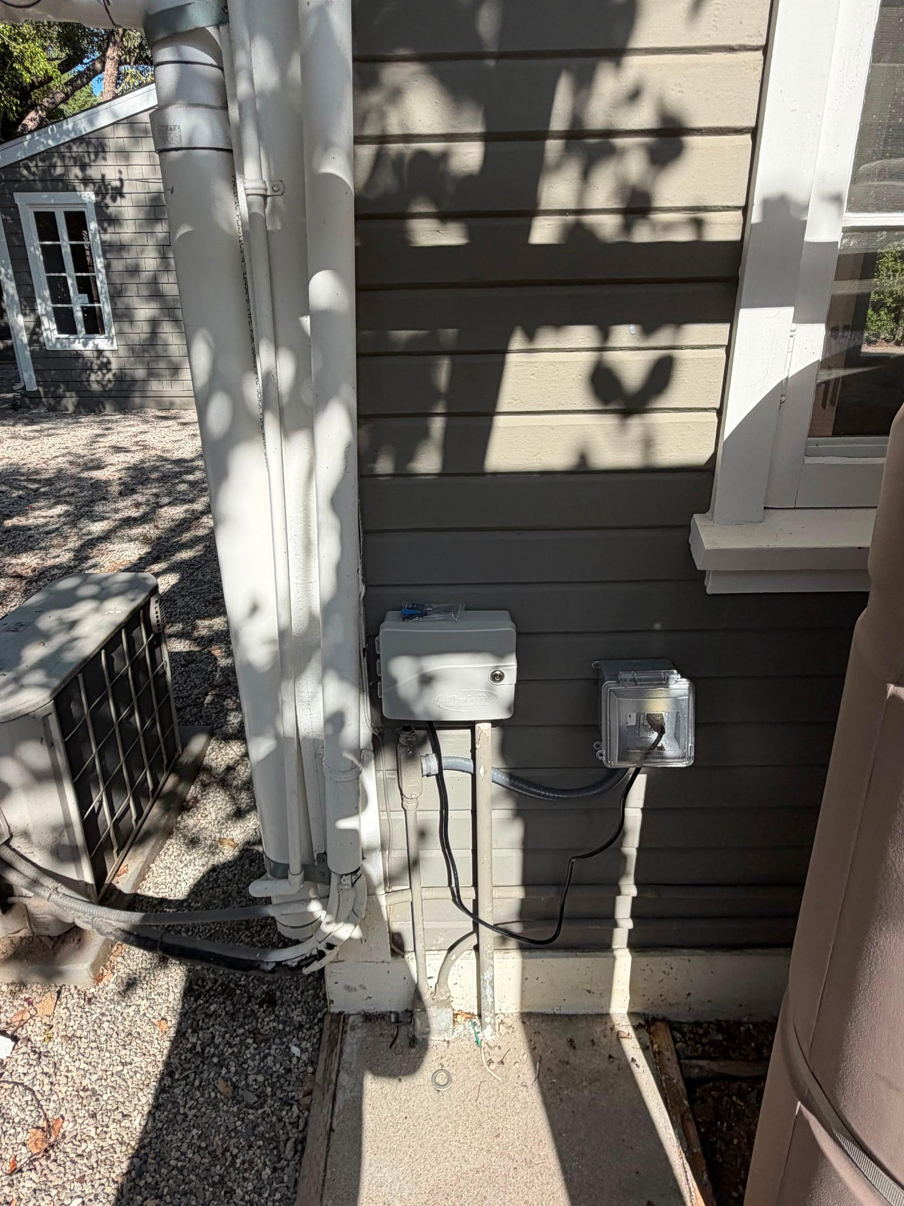 Irrigation controller mounted on an exterior wall