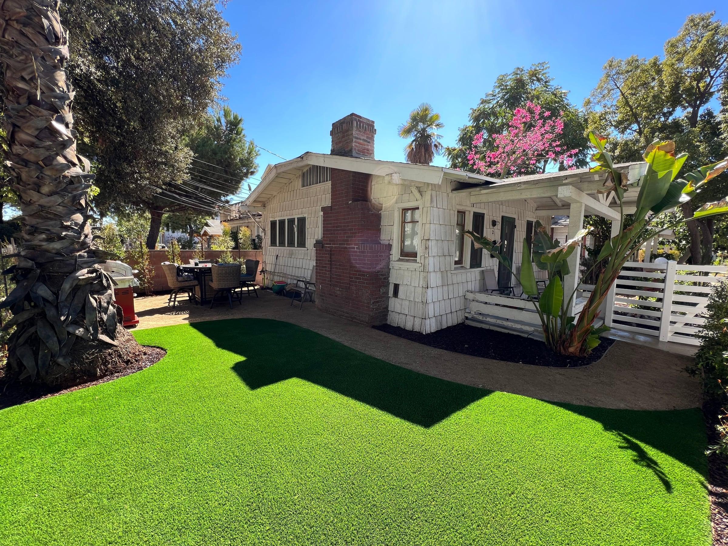 Backyard with freshly installed artificial turf lawn